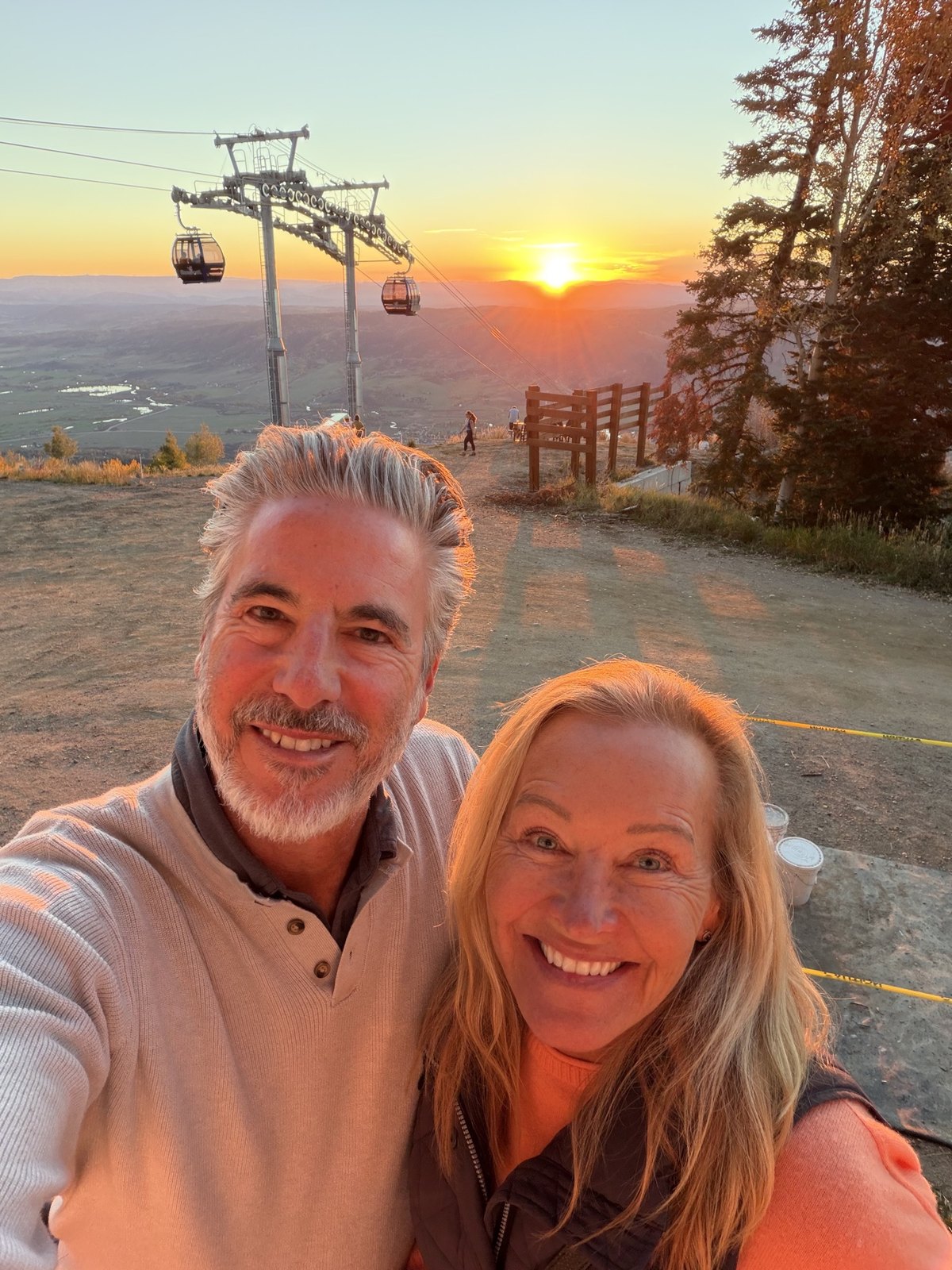 Vickie and Oren at the top of the gondola in Steamboat Springs as the sun sets over the Yampa Valley